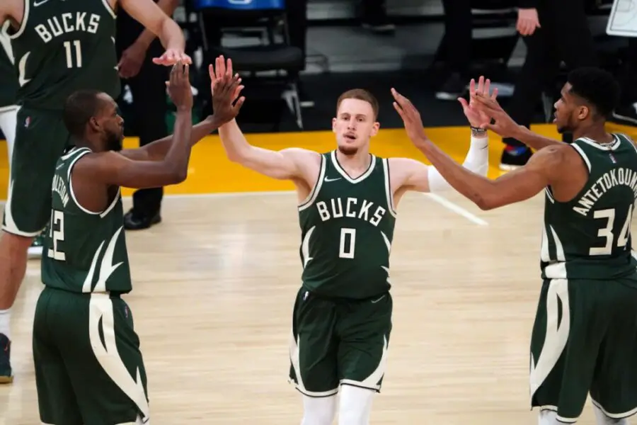 Mar 31, 2021; Los Angeles, California, USA; Milwaukee Bucks guard Donte DiVincenzo (0) celebrates with forward Khris Middleton (22) and forward Giannis Antetokounmpo (34) in the second half against the Los Angeles Lakers at Staples Center. Mandatory Credit: Kirby Lee-USA TODAY Sports