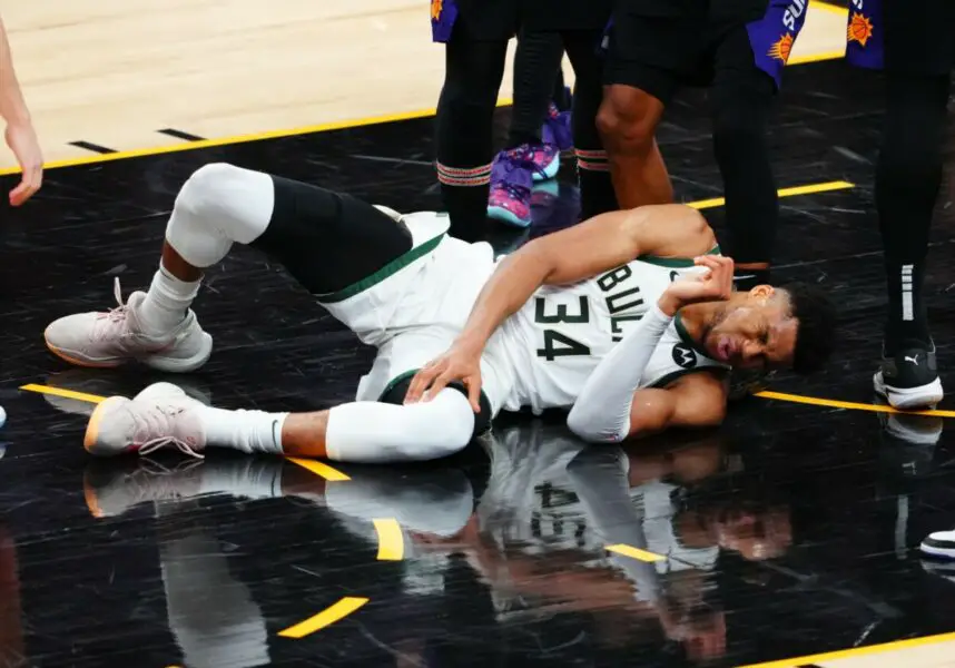 Jul 8, 2021; Phoenix, Arizona, USA; Milwaukee Bucks forward Giannis Antetokounmpo (34) reacts after suffering an injury against the Phoenix Suns in game two of the 2021 NBA Finals at Phoenix Suns Arena. Mandatory Credit: Mark J. Rebilas-USA TODAY Sports