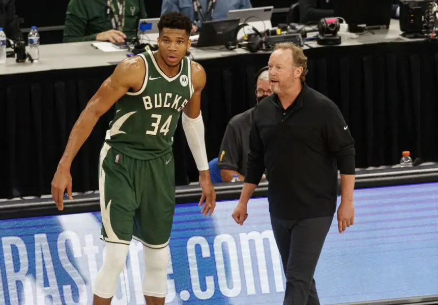 Jul 11, 2021; Milwaukee, Wisconsin, USA; Milwaukee Bucks head coach Mike Budenholzer talks with forward Giannis Antetokounmpo (34) during the third quarter against the Phoenix Suns during game three of the 2021 NBA Finals at Fiserv Forum. Mandatory Credit: Jeff Hanisch-USA TODAY Sports NBA News
