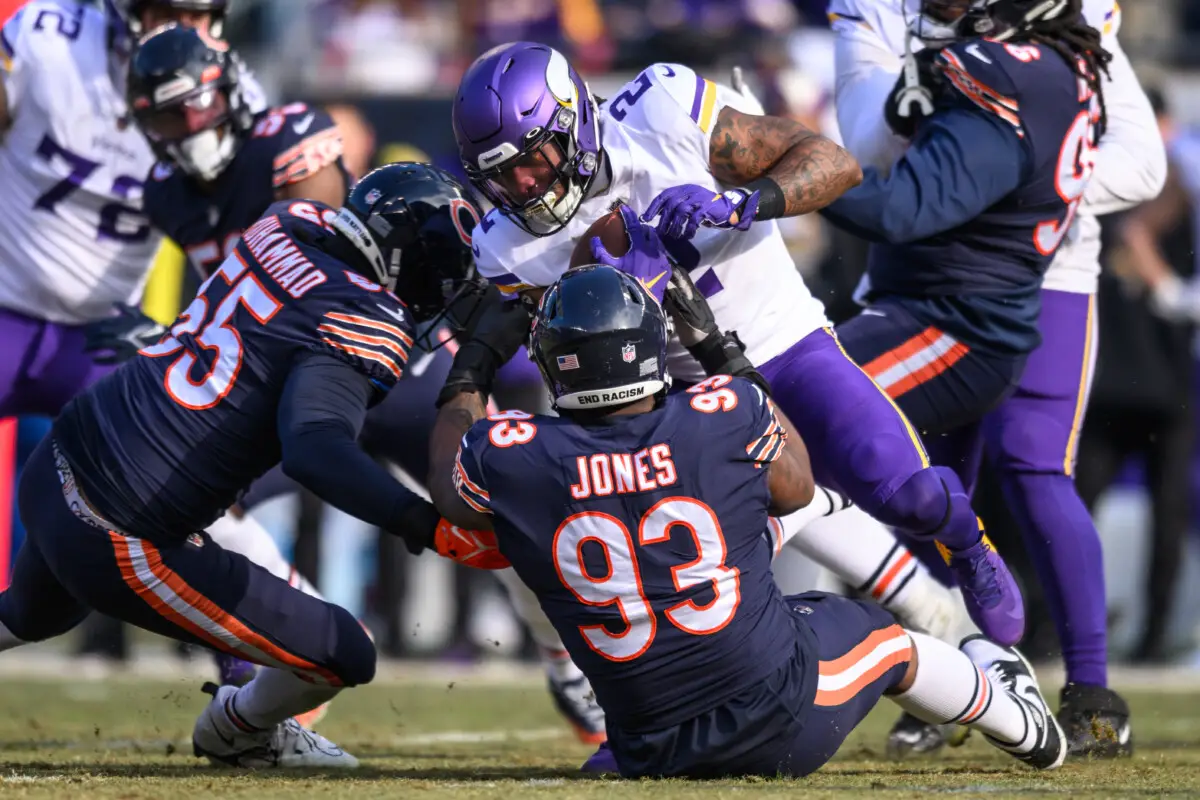 Jan 8, 2023; Chicago, Illinois, USA; Minnesota Vikings running back Alexander Mattison (2) runs the ball and is tackled by Chicago Bears defensive end Al-Quadin Muhammad (55) and defensive tackle Justin Jones (93) during the first quarter at Soldier Field. Mandatory Credit: Daniel Bartel-USA TODAY Sports (NFL News) Green Bay Packers