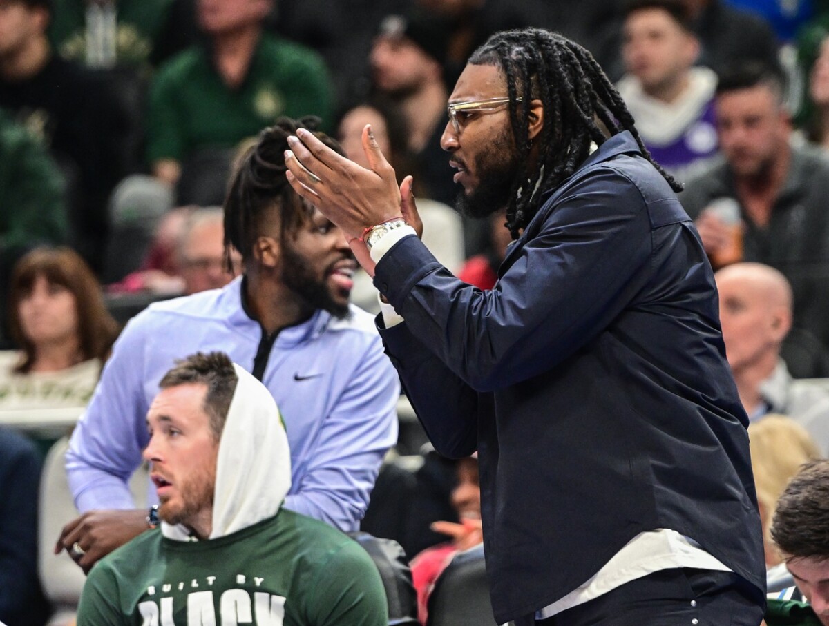 Feb 14, 2023; Milwaukee, Wisconsin, USA; Milwaukee Bucks forward Jae Crowder (99) cheers his new team from the bench in the second quarter during game against the Boston Celtics at Fiserv Forum. Mandatory Credit: Benny Sieu-USA TODAY Sports NBA Rumors