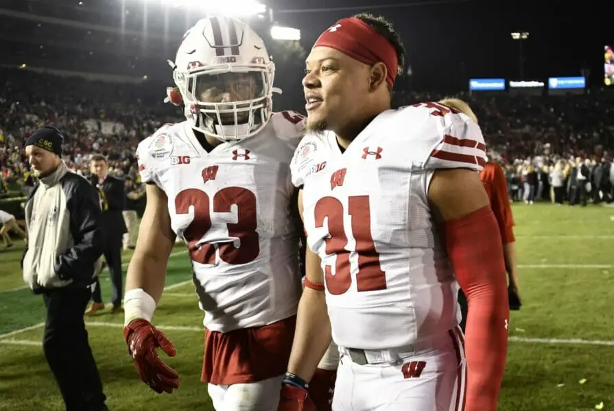 Jan 1, 2020; Pasadena, California, USA; Wisconsin Badgers running back Jonathan Taylor (23) and safety Madison Cone (31) leave the field after the 106th Rose Bowl game at Rose Bowl Stadium. The Oregon Ducks defeated the Wisconsin Badgers 28-27. Mandatory Credit: Robert Hanashiro-USA TODAY Sports (NFL News)