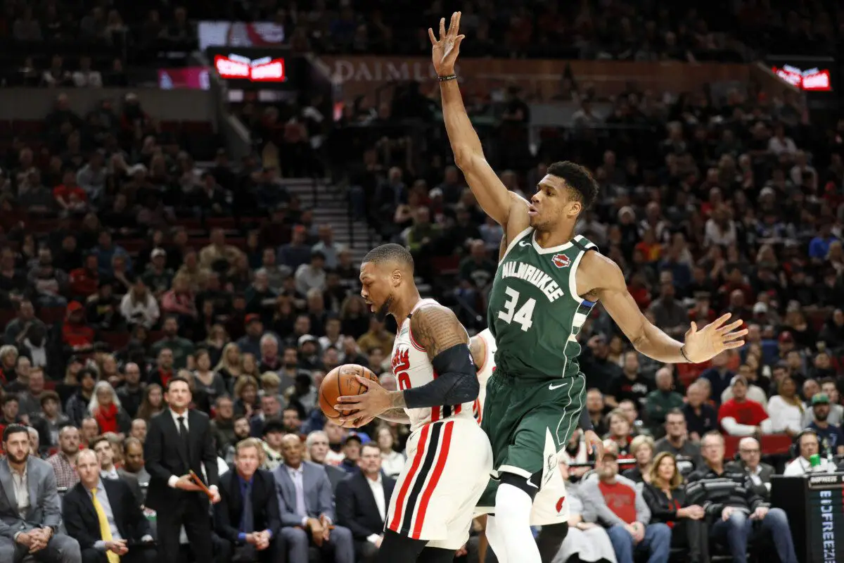 Jan 11, 2020; Portland, Oregon, USA; Portland Trail Blazers point guard Damian Lillard (0) grabs a rebound ahead of Milwaukee Bucks power forward Giannis Antetokounmpo (34) during the first half at Moda Center. Mandatory Credit: Soobum Im-USA TODAY Sports (NBA News)