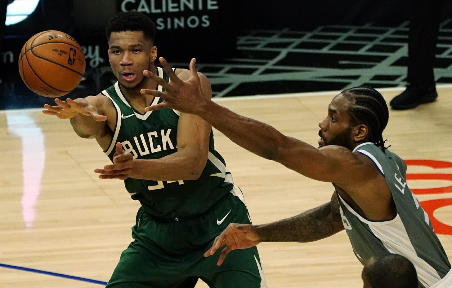 Mar 29, 2021; Los Angeles, California, USA; Milwaukee Bucks forward Giannis Antetokounmpo (34) passes against the defense of Los Angeles Clippers forward Kawhi Leonard (2) during the first half at Staples Center. Mandatory Credit: Gary A. Vasquez-USA TODAY Sports (NBA RUmors)