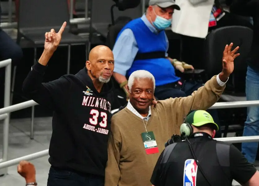 Jul 14, 2021; Milwaukee, Wisconsin, USA; NBA former player Kareem Abdul-Jabbar and former player Oscar Robertson wave to the crowd during the second quarter in game four of the 2021 NBA Finals between the Milwaukee Bucks and the Phoenix Suns at Fiserv Forum. Mandatory Credit: Mark J. Rebilas-USA TODAY Sports (NBA News)