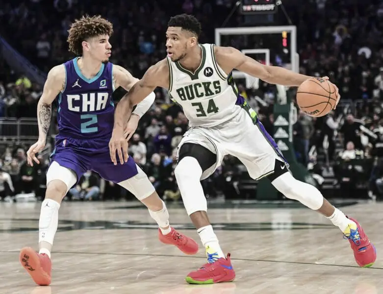 Dec 1, 2021; Milwaukee, Wisconsin, USA; Milwaukee Bucks forward Giannis Antetokounmpo (34) drives for the basket against Charlotte Hornets guard LaMelo Ball (2) in the fourth quarter at Fiserv Forum. Mandatory Credit: Benny Sieu-USA TODAY Sports (NBA News)