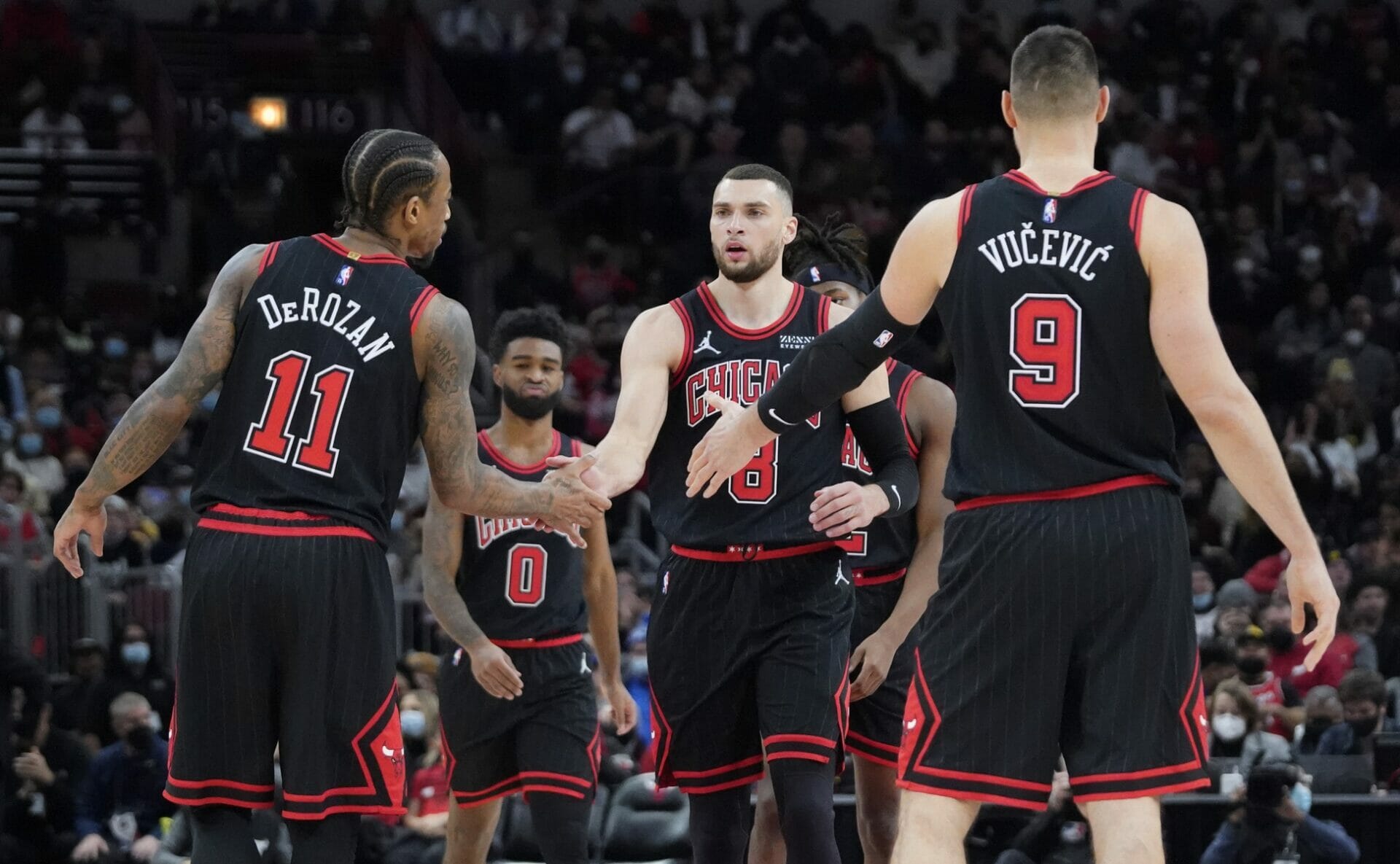 Dec 26, 2021; Chicago, Illinois, USA; Chicago Bulls guard Zach LaVine (8) celebrates a three point basket against the Indiana Pacers with forward DeMar DeRozan (11) and center Nikola Vucevic (9) during the second half at United Center. Mandatory Credit: David Banks-USA TODAY Sports (NBA Rumors)