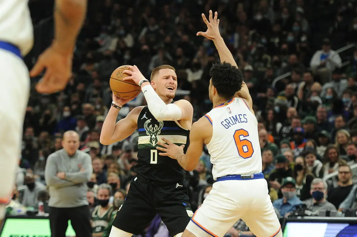 Jan 28, 2022; Milwaukee, Wisconsin, USA;  Milwaukee Bucks guard Donte DiVincenzo (0) reacts as he is being guarded by New York Knicks guard Quentin Grimes (6) in the first half at Fiserv Forum. Mandatory Credit: Michael McLoone-USA TODAY Sports (NBA News)