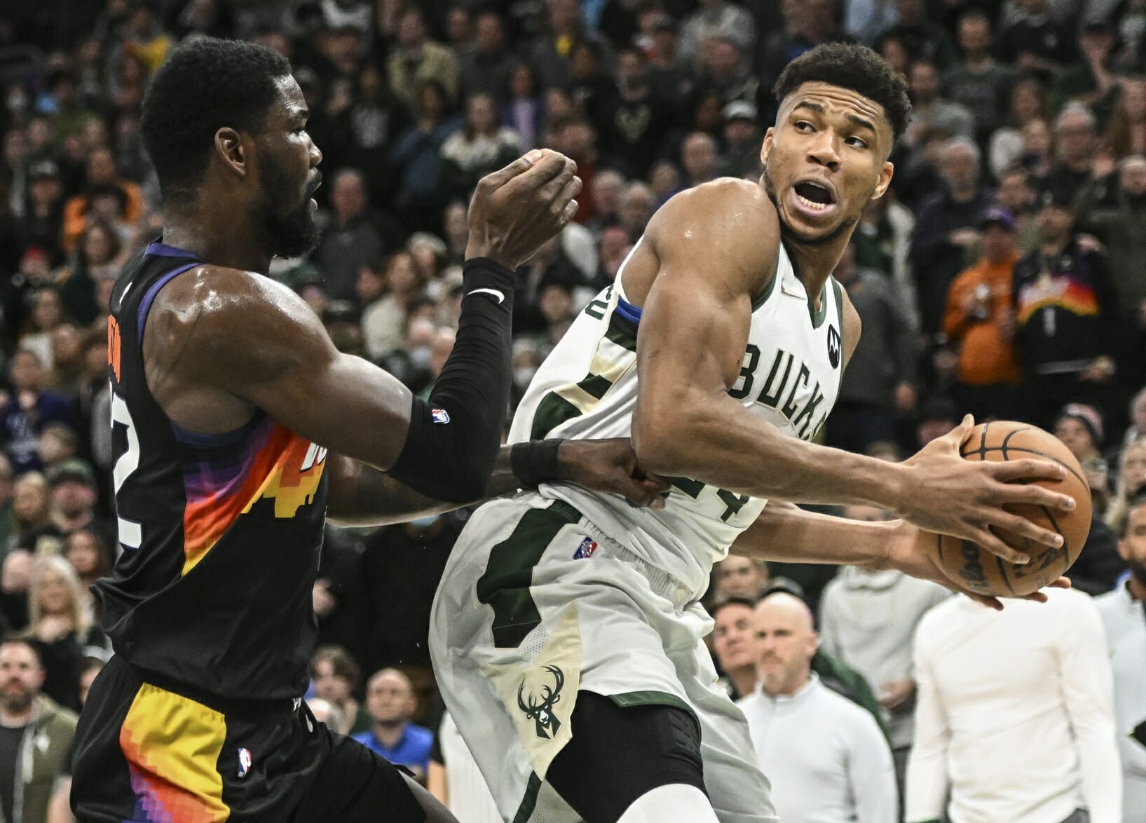 Mar 6, 2022; Milwaukee, Wisconsin, USA; Milwaukee Bucks forward Giannis Antetokounmpo (34) looks for a shot against Phoenix Suns center Deandre Ayton (22) in the fourth quarter at Fiserv Forum. Mandatory Credit: Benny Sieu-USA TODAY Sports (NBA News)