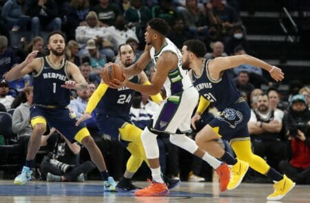 Mar 26, 2022; Memphis, Tennessee, USA; Milwaukee Bucks forward Giannis Antetokounmpo (34) controls the ball against Memphis Grizzlies forward Kyle Anderson (1) and forward Dillon Brooks (24) and guard Tyus Jones (21) during the first half at FedExForum. Mandatory Credit: Christine Tannous-USA TODAY Sports (NBA News)