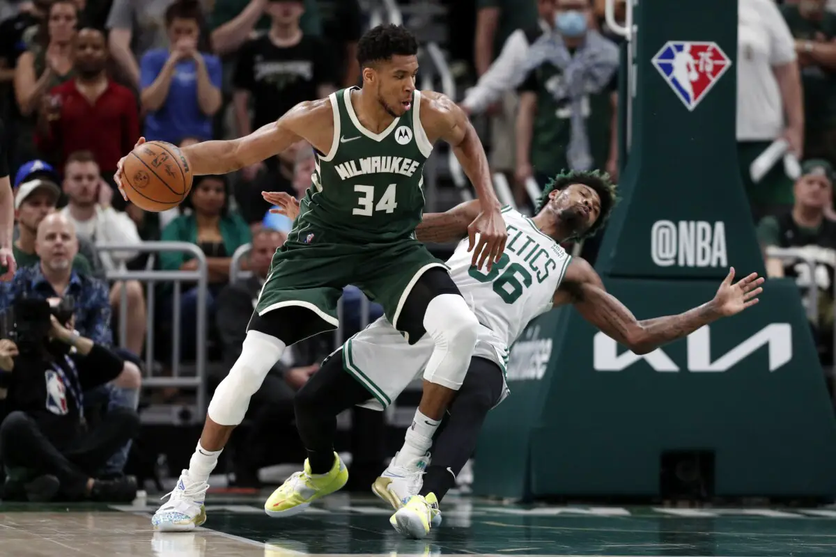 May 13, 2022; Milwaukee, Wisconsin, USA; Boston Celtics guard Marcus Smart (36) falls away from Milwaukee Bucks forward Giannis Antetokounmpo (34) during the fourth quarter during game six of the second round for the 2022 NBA playoffs at Fiserv Forum. Mandatory Credit: Jeff Hanisch-USA TODAY Sports (NBA News)