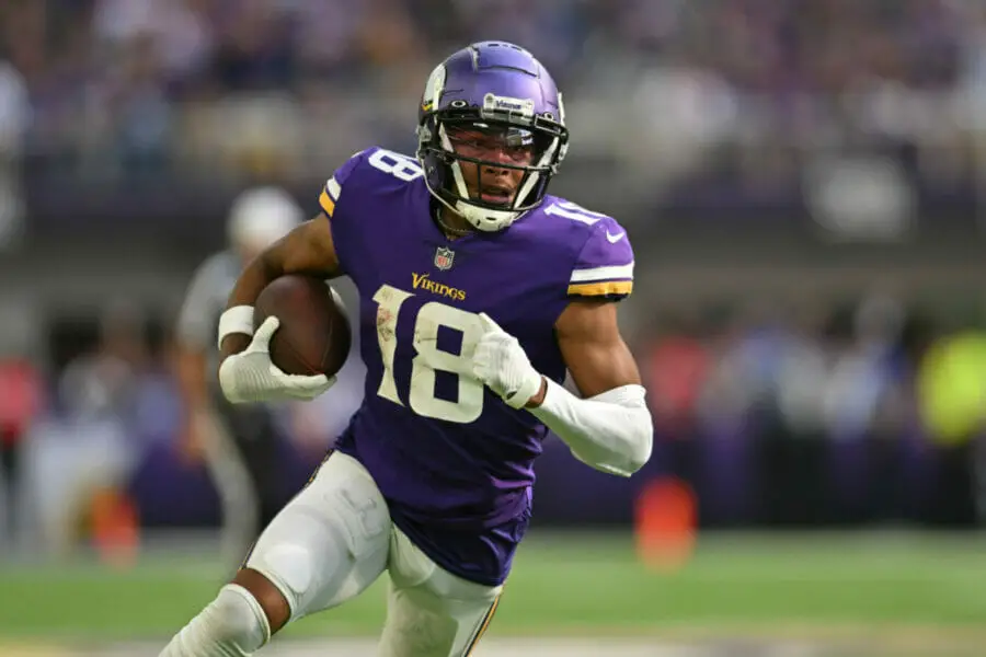 Sep 11, 2022; Minneapolis, Minnesota, USA; Minnesota Vikings wide receiver Justin Jefferson (18) scores a touchdown on a pass from quarterback Kirk Cousins (not pictured) against the Green Bay Packers during the second quarter at U.S. Bank Stadium. Mandatory Credit: Jeffrey Becker-USA TODAY Sports