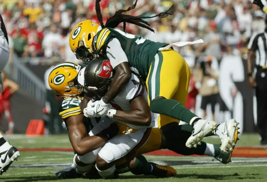 Sep 25, 2022; Tampa, Florida, USA;Tampa Bay Buccaneers running back Leonard Fournette (7) is brought down by Green Bay Packers linebacker De'Vondre Campbell (59) and linebacker Rashan Gary (52) during the first quarter at Raymond James Stadium. Mandatory Credit: Kim Klement-USA TODAY Sports