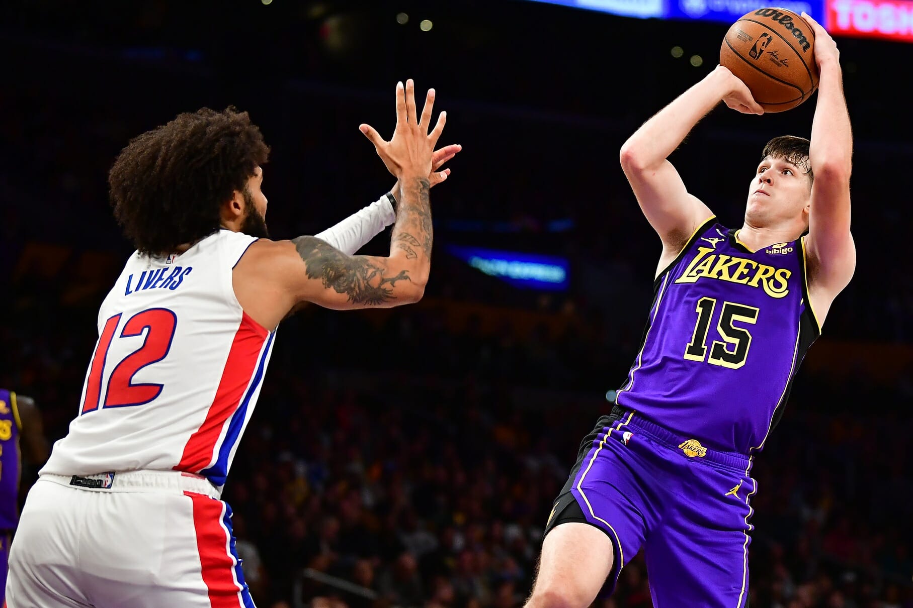 Nov 18, 2022; Los Angeles, California, USA; Los Angeles Lakers guard Austin Reaves (15) shoots against Detroit Pistons forward Isaiah Livers (12) during the second half at Crypto.com Arena. Mandatory Credit: Gary A. Vasquez-USA TODAY Sports (NBA News)