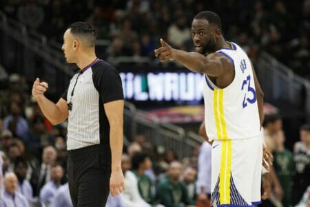 Dec 13, 2022; Milwaukee, Wisconsin, USA; Golden State Warriors forward Draymond Green (23) points out a fan in the stands to a referee during the third quarter against the Milwaukee Bucks at Fiserv Forum. Mandatory Credit: Jeff Hanisch-USA TODAY Sports (NBA News)