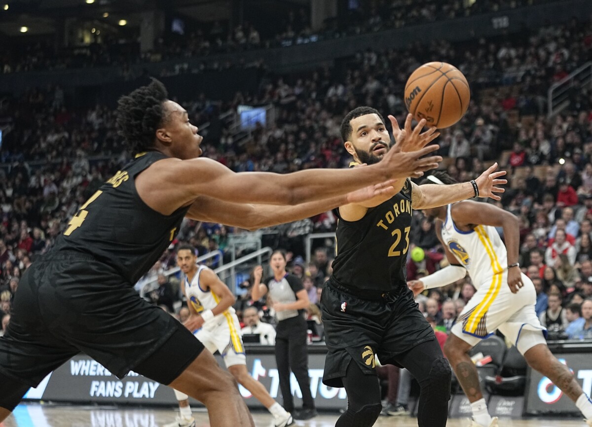 Dec 18, 2022; Toronto, Ontario, CAN; Toronto Raptors guard Fred VanVleet (23) and forward Scottie Barnes (4) reach for a rebound against the Golden State Warriors during the first half at Scotiabank Arena. Mandatory Credit: John E. Sokolowski-USA TODAY Sports (NBA News)