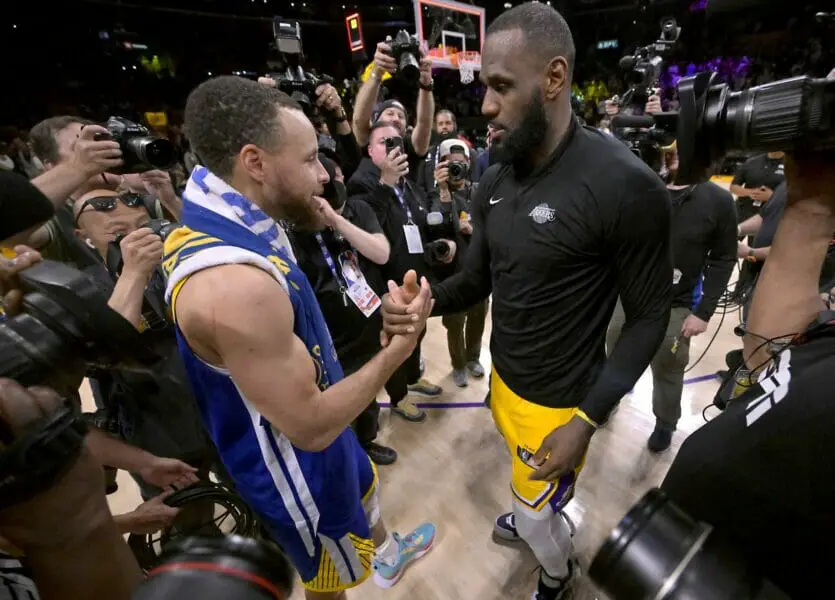 May 12, 2023; Los Angeles, California, USA; Los Angeles Lakers forward LeBron James (6) and Golden State Warriors guard Stephen Curry (30) embrace after game six of the 2023 NBA playoffs at Crypto.com Arena. Mandatory Credit: Jayne Kamin-Oncea-USA TODAY Sports (NBA News)