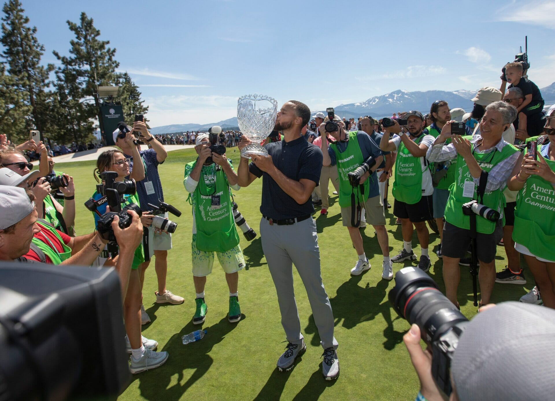 Stephen Curry celebrates kissing the trophy after sinking the winning putt during the final round of the American Century Celebrity Championship golf tournament at Edgewood Tahoe Golf Course in Stateline, Nev., Sunday, July 16, 2023. (NBA News)