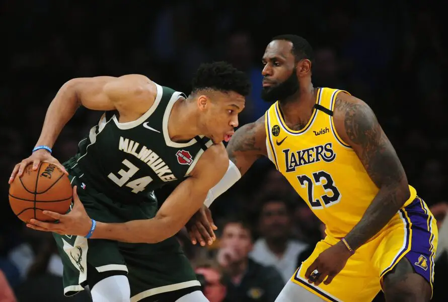 March 6, 2020; Los Angeles, California, USA; Milwaukee Bucks forward Giannis Antetokounmpo (34) controls the ball against Los Angeles Lakers forward LeBron James (23) during the first half at Staples Center. Mandatory Credit: Gary A. Vasquez-USA TODAY Sports (NBA News)