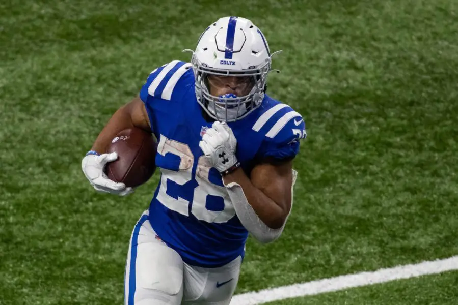 Nov 22, 2020; Indianapolis, Indiana, USA; Indianapolis Colts running back Jonathan Taylor (28) runs the ball in the second half against the Green Bay Packers at Lucas Oil Stadium. Mandatory Credit: Trevor Ruszkowski-USA TODAY Sports (Green Bay Packers)