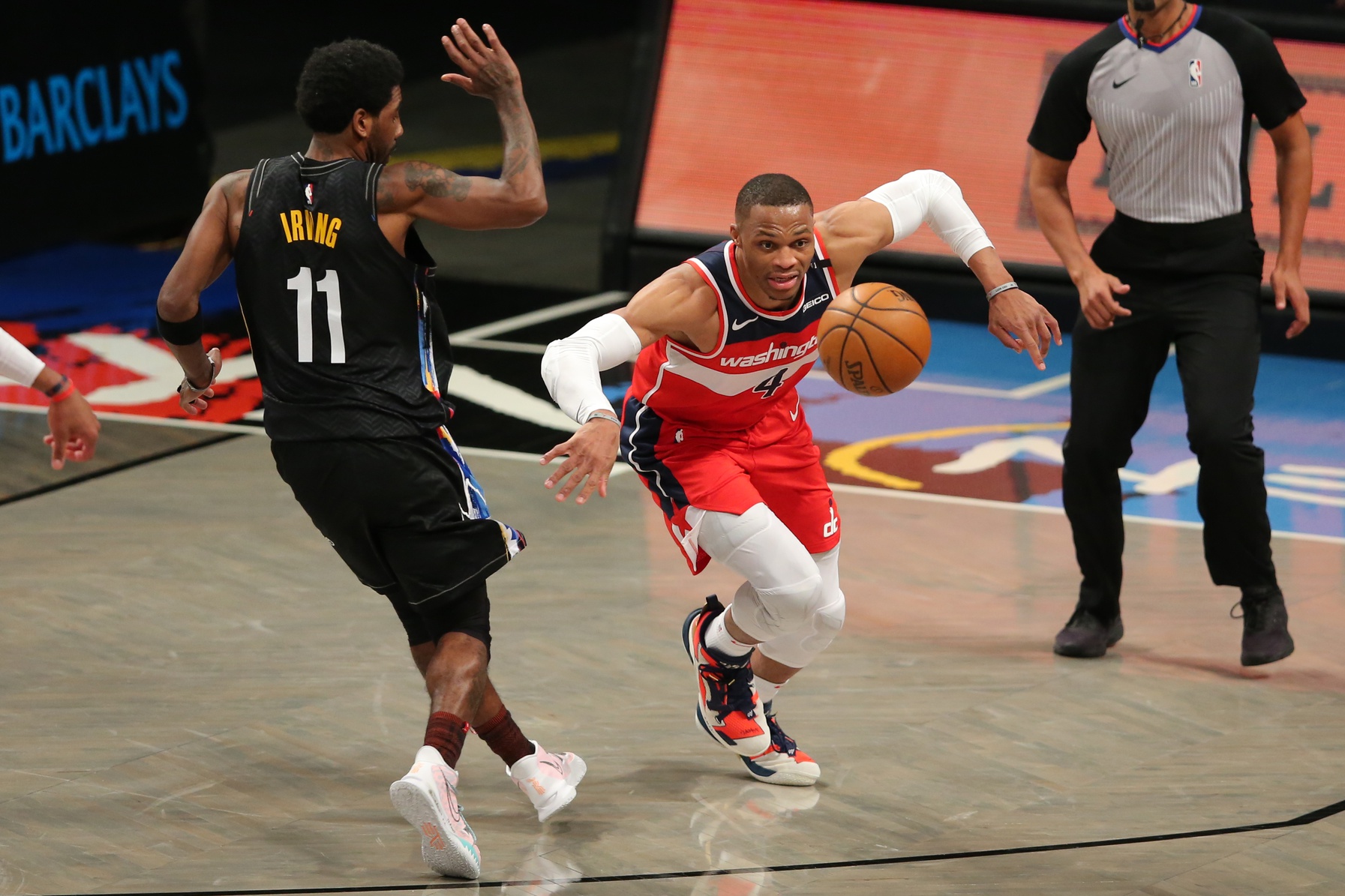 Mar 21, 2021; Brooklyn, New York, USA; Washington Wizards point guard Russell Westbrook (4) chases a loose ball against Brooklyn Nets point guard Kyrie Irving (11) during the fourth quarter at Barclays Center. Mandatory Credit: Brad Penner-USA TODAY Sports (NBA News)