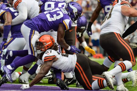 Oct 3, 2021; Minneapolis, Minnesota, USA; Cleveland Browns running back Kareem Hunt (27) reaches for the endzone to score a touchdown as Minnesota Vikings free safety Xavier Woods (23) defends during the second quarter at U.S. Bank Stadium. Mandatory Credit: Jeffrey Becker-USA TODAY Sports (NFC North News)