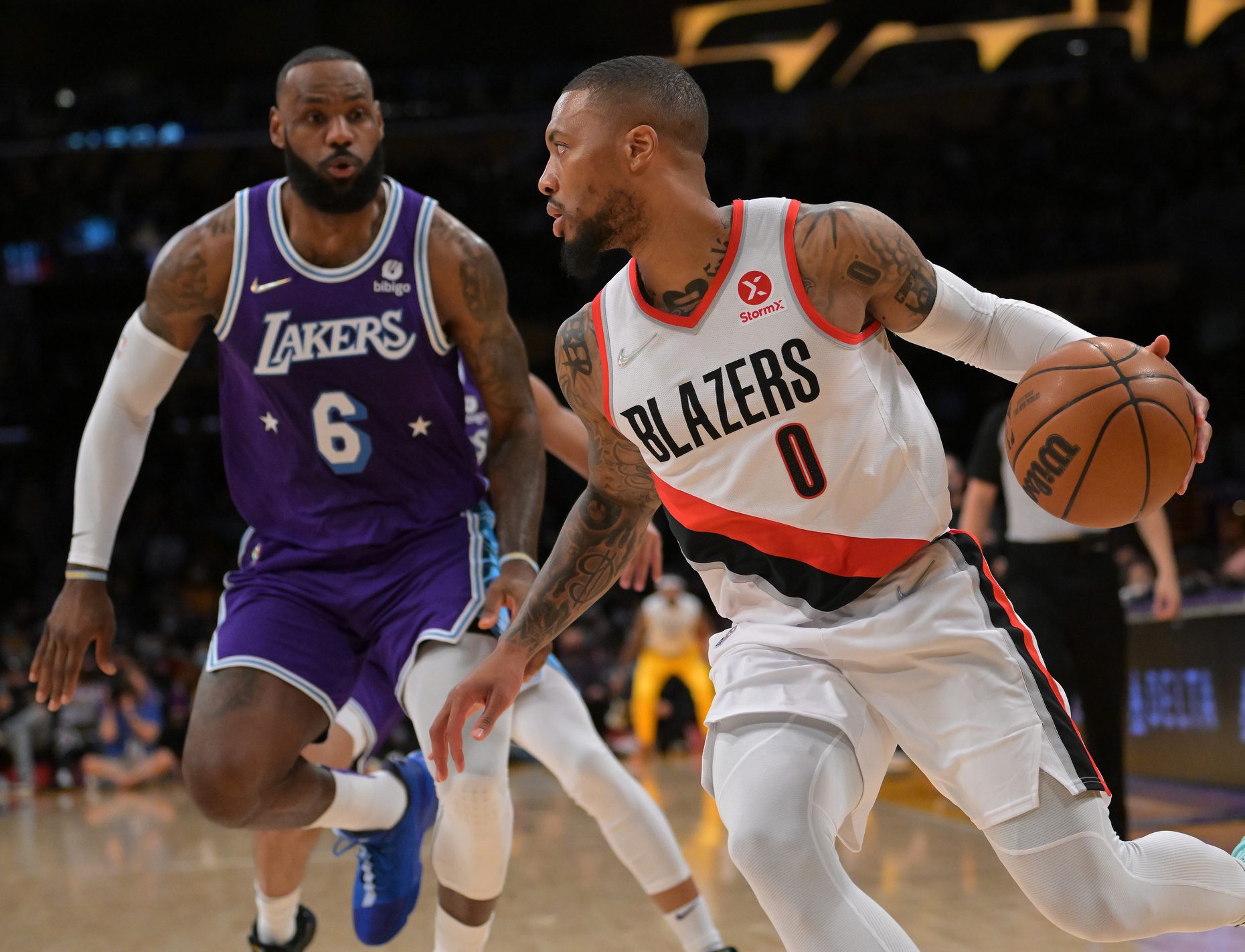 Dec 31, 2021; Los Angeles, California, USA; Portland Trail Blazers guard Damian Lillard (0) drives past Los Angeles Lakers forward LeBron James (6) in the first quarter at Crypto.com Arena. Mandatory Credit: Jayne Kamin-Oncea-USA TODAY Sports (NBA Rumors)