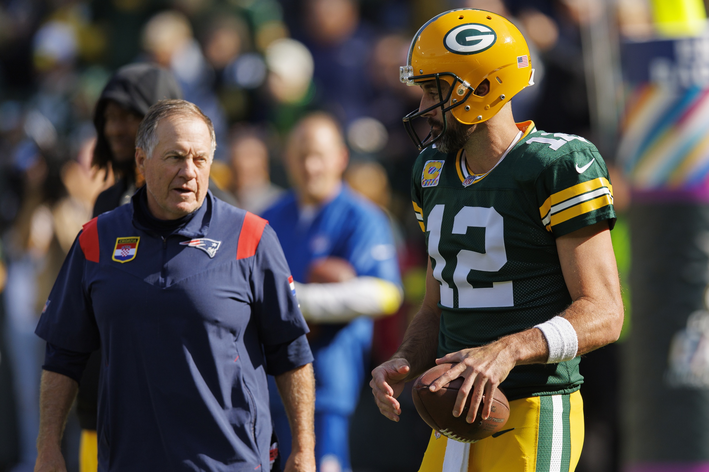 Oct 2, 2022; Green Bay, Wisconsin, USA; Green Bay Packers quarterback Aaron Rodgers (12) talks with New England Patriots head coach Bill Belichick during warmups prior to the game at Lambeau Field. Mandatory Credit: Jeff Hanisch-USA TODAY Sports