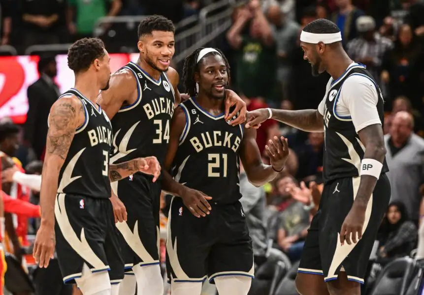 Oct 29, 2022; Milwaukee, Wisconsin, USA; Milwaukee Bucks guard George Hill (3) and forward Giannis Antetokounmpo (34) and guard Jrue Holiday (21) and forward Bobby Portis (9) celebrate after a score late in the fourth quarter during game against the Atlanta Hawks at Fiserv Forum. Mandatory Credit: Benny Sieu-USA TODAY Sports