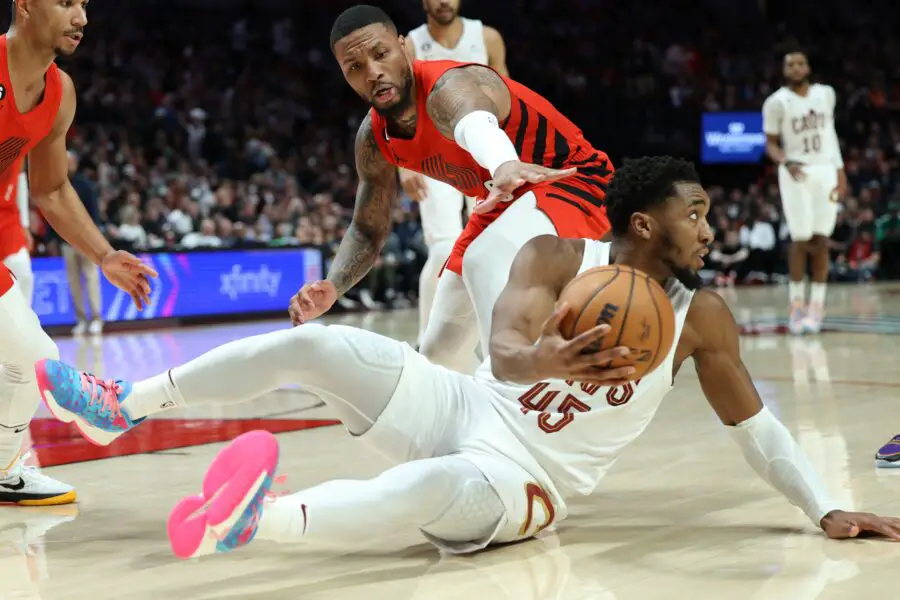 Jan 12, 2023; Portland, Oregon, USA; Cleveland Cavaliers guard Donovan Mitchell (45) looks to pass the ball Portland Trail Blazers guard Damian Lillard (0) in the first half at Moda Center. Mandatory Credit: Jaime Valdez-USA TODAY Sports (NBA News)