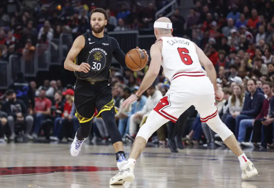 Jan 15, 2023; Chicago, Illinois, USA; Golden State Warriors guard Stephen Curry (30) brings the ball up court against Chicago Bulls guard Alex Caruso (6) during the first half of an NBA game at United Center. Mandatory Credit: Kamil Krzaczynski-USA TODAY Sports