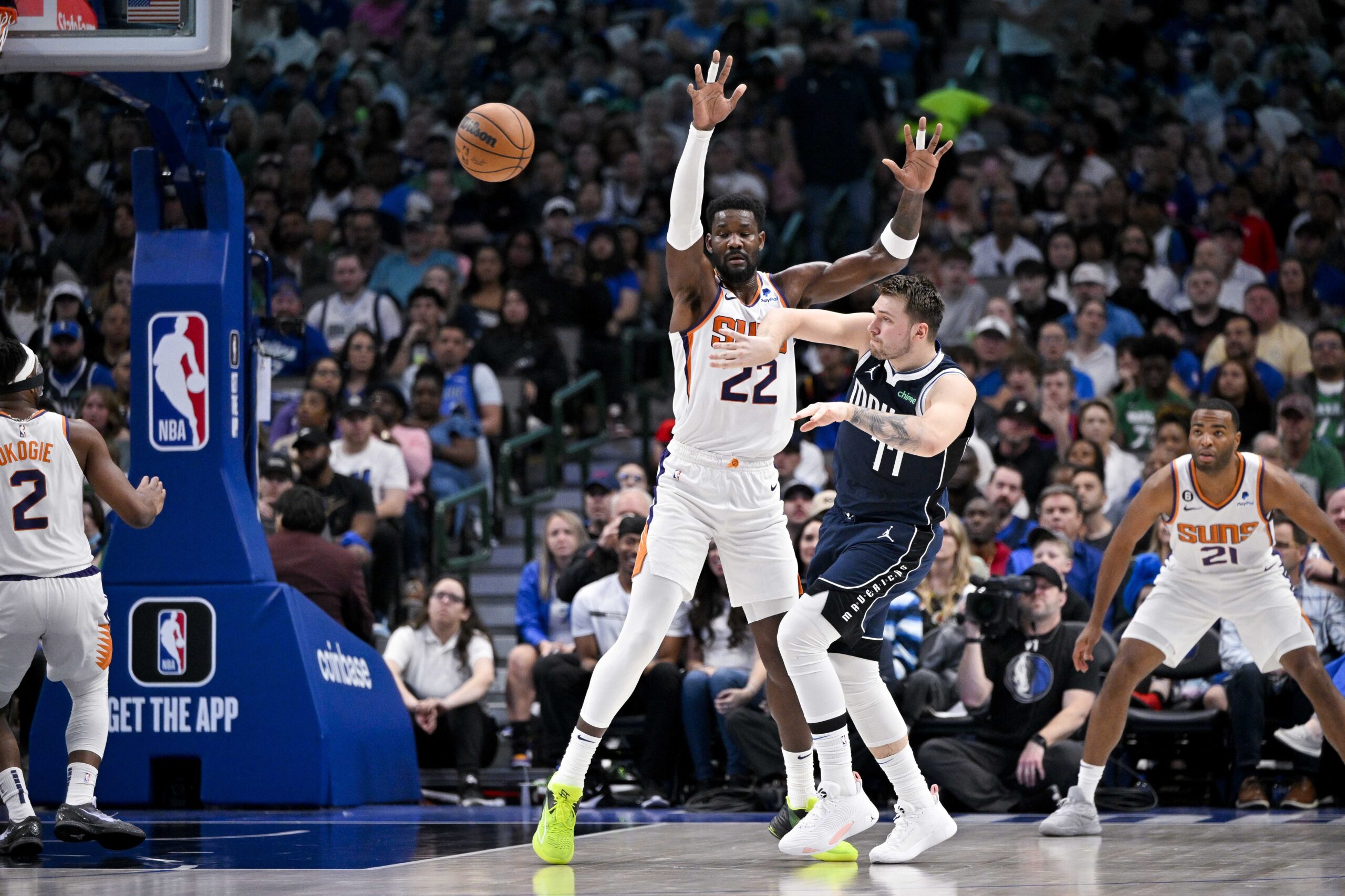 Mar 5, 2023; Dallas, Texas, USA; Dallas Mavericks guard Luka Doncic (77) passes the ball around Phoenix Suns center Deandre Ayton (22) during the second quarter at the American Airlines Center. Mandatory Credit: Jerome Miron-USA TODAY Sports NBA Rumors