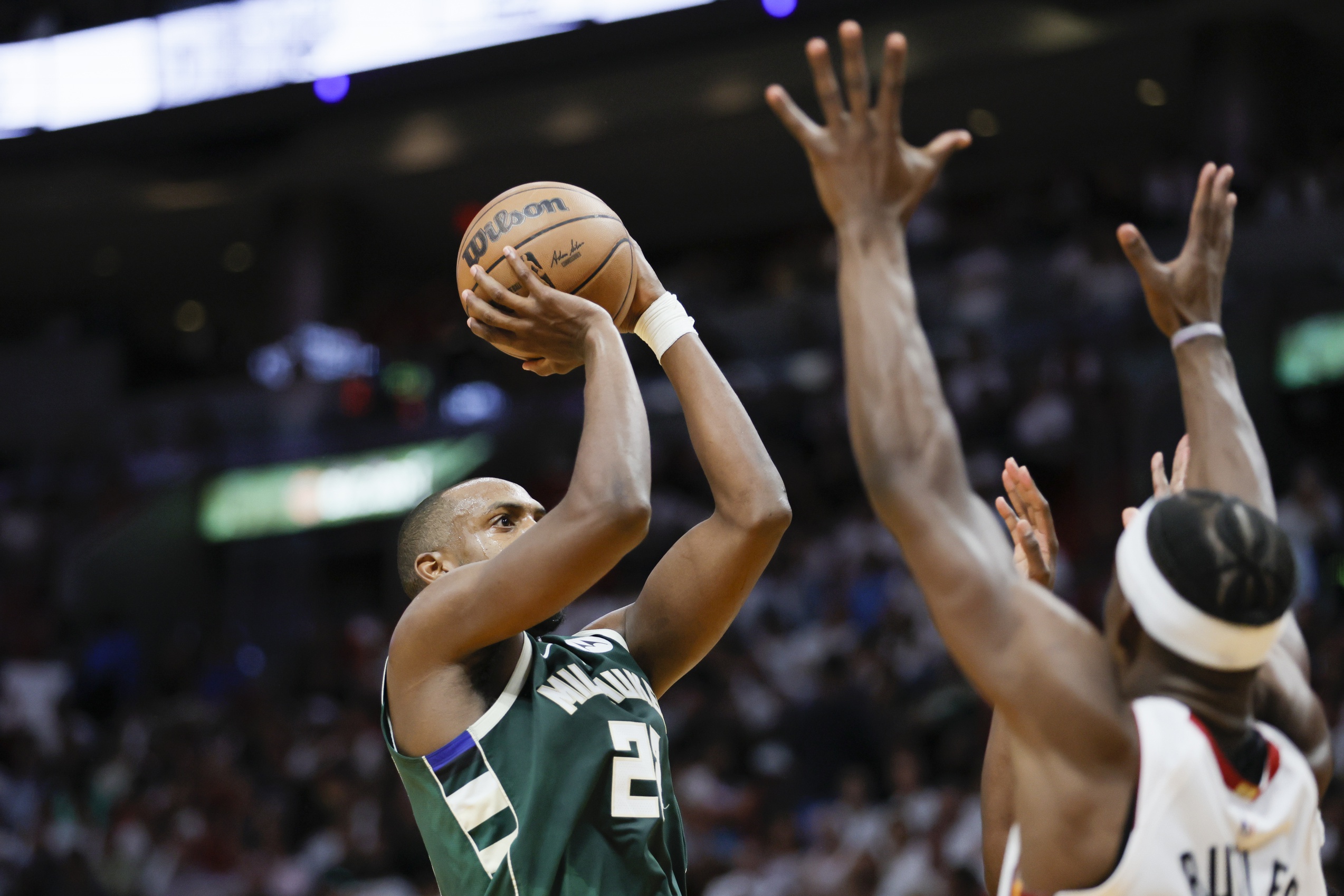 Milwaukee Bucks forward Khris Middleton shoots over Miami Heat star Jimmy Butler