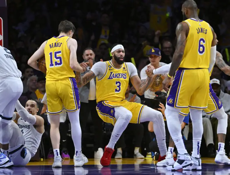 Apr 28, 2023; Los Angeles, California, USA; Los Angeles Lakers guard Austin Reaves (15) and forward LeBron James (6) give a hand to forward Anthony Davis (3) after he was fouled by Memphis Grizzlies guard Desmond Bane (22) in the first half of game six of the 2023 NBA playoffs at Crypto.com Arena. Mandatory Credit: Jayne Kamin-Oncea-USA TODAY Sports (NBA News)