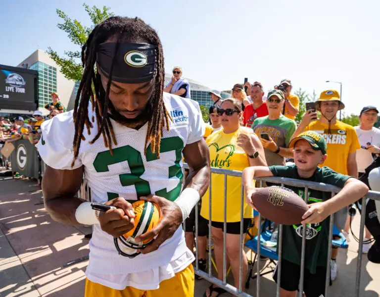 Green Bay Packers running back Aaron Jones (33) signs a fan's miniature helmet after the DreamDrive bicycle ride during the second day of the team's 2023 training camp on Thursday, July 27, 2023, in Green Bay, Wis. Seeger Gray/USA TODAY NETWORK-Wisconsin