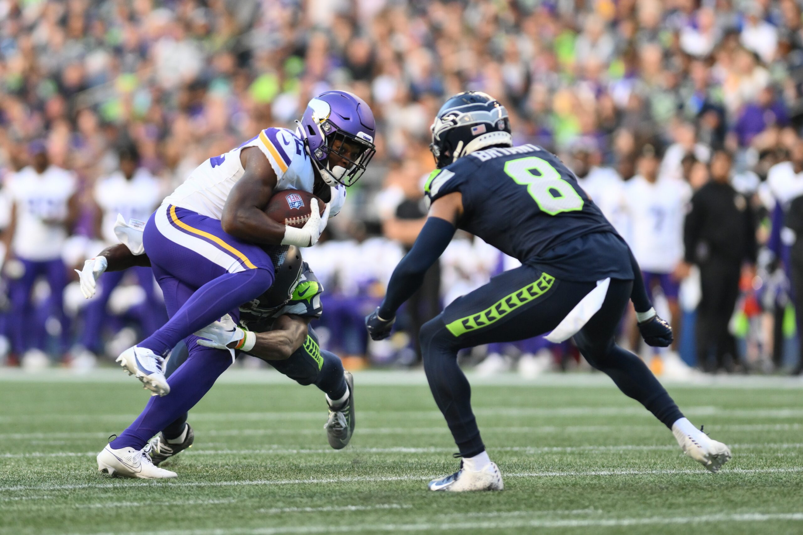 Aug 10, 2023; Seattle, Washington, USA; Minnesota Vikings running back Ty Chandler (32) carries the ball while being tackled by Seattle Seahawks cornerback Michael Jackson (30) during the first half at Lumen Field. Mandatory Credit: Steven Bisig-USA TODAY Sports (NFC North News)