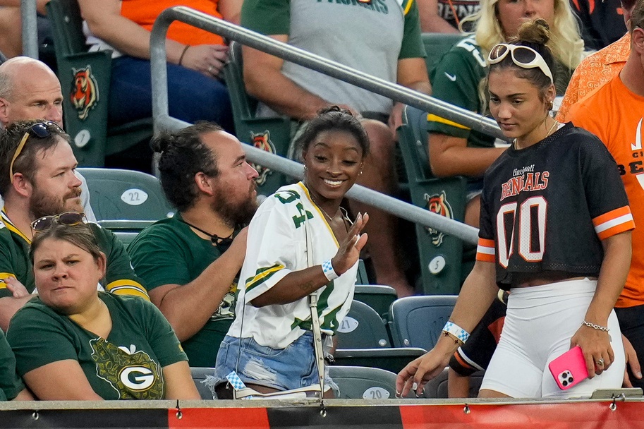 US Olympian Simone Biles finds her seat behind the Packers bench in the second quarter of the NFL Preseason Week 1 game between the Cincinnati Bengals and the Green Bay Packers at Paycor Stadium in downtown Cincinnati on Friday, Aug. 11, 2023. The Packers led 21-16 at halftime. (Packers News) 