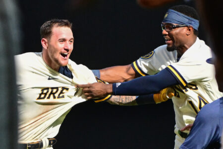 Aug 23, 2023; Milwaukee, Wisconsin, USA; Milwaukee Brewers second baseman Brice Turang (2) celebrates with third baseman Andruw Monasterio (14) after driving in the winning run in the tenth inning against the Minnesota Twins at American Family Field. Mandatory Credit: Benny Sieu-USA TODAY Sports