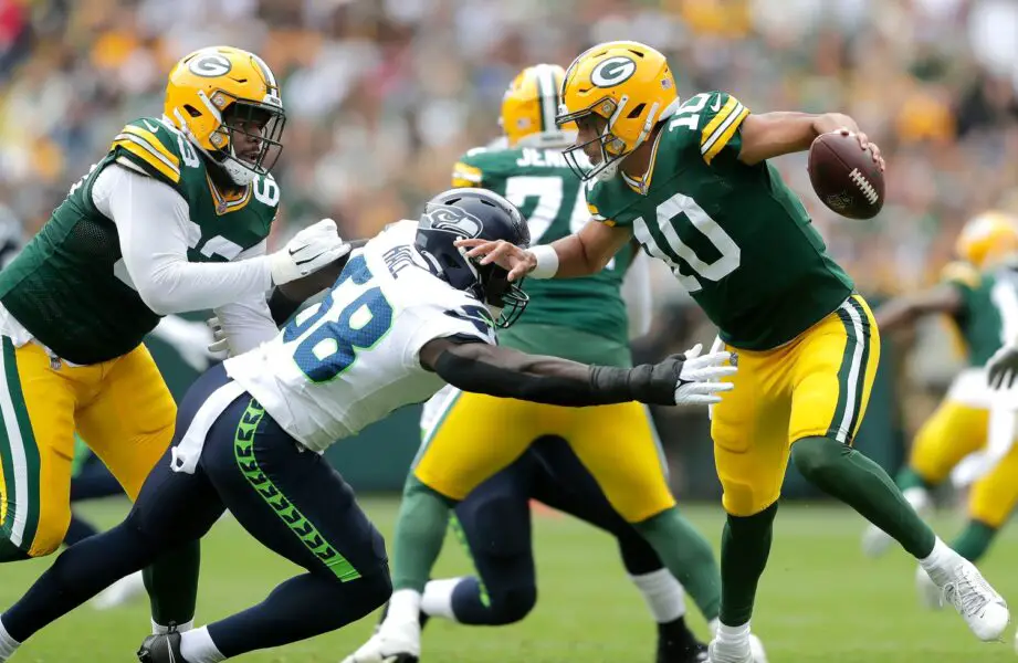 Green Bay Packers quarterback Jordan Love (10) dodges pressure from Seattle Seahawks linebacker Derick Hall (58) during their preseason football game Saturday, August 26, 2023, at Lambeau Field in Green Bay, Wis. Green Bay defeated Seattle 19-15. Wm. Glasheen USA TODAY NETWORK-Wisconsin