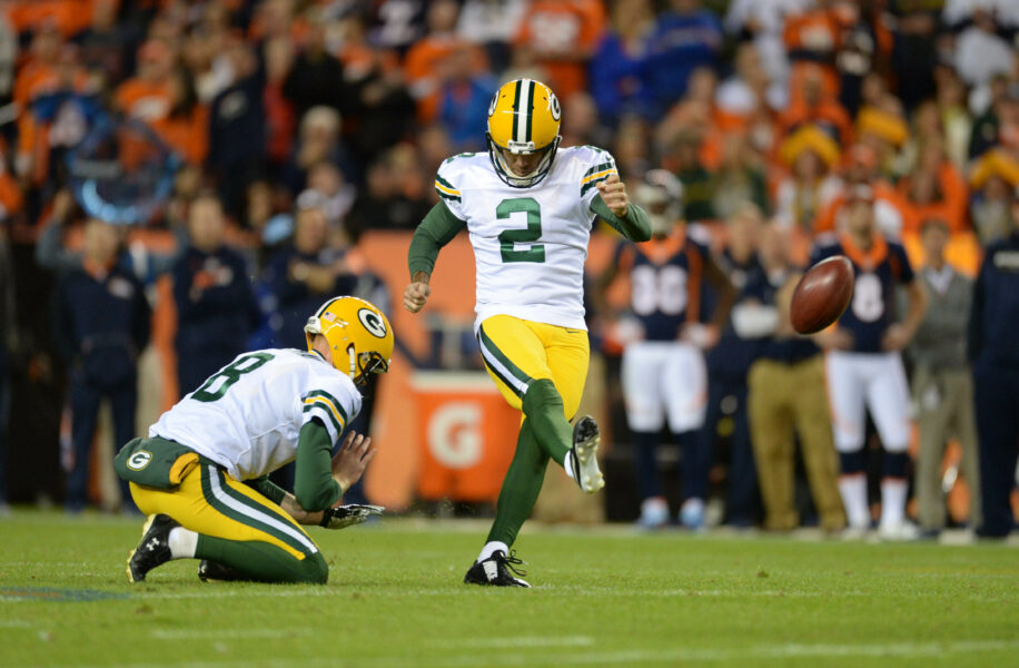 Nov 1, 2015; Denver, CO, USA; Green Bay Packers kicker Mason Crosby (2) attempts a field goal as Green Bay Packers punter Tim Masthay (8) held in the third quarter against the Denver Broncos at Sports Authority Field at Mile High. Mandatory Credit: Ron Chenoy-USA TODAY Sports