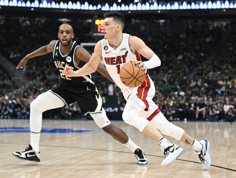 Apr 16, 2023; Milwaukee, Wisconsin, USA; Miami Heat guard Tyler Herro (14) drives to the basket against Milwaukee Bucks forward Khris Middleton (22) in the first half during game one of the 2023 NBA Playoffs at Fiserv Forum. Mandatory Credit: Michael McLoone-USA TODAY Sports
