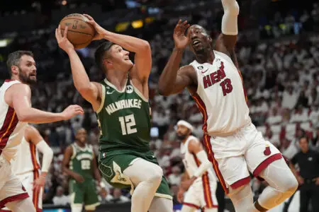 Apr 24, 2023; Miami, Florida, USA; Milwaukee Bucks guard Grayson Allen (12) drives to the basket as Miami Heat center Bam Adebayo (13) defends in the first quarter during game four of the 2023 NBA Playoffs at Kaseya Center. Mandatory Credit: Jim Rassol-USA TODAY Sports