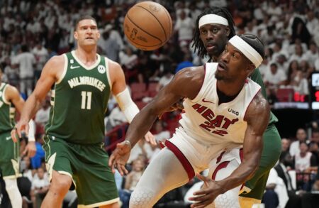 Apr 24, 2023; Miami, Florida, USA; Miami Heat forward Jimmy Butler (22) loses the ball as Milwaukee Bucks guard Jrue Holiday (21) and center Brook Lopez (11) look on in the third quarter during game four of the 2023 NBA Playoffs at Kaseya Center. Mandatory Credit: Jim Rassol-USA TODAY Sports