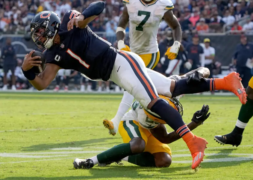 Sep 10, 2023; Chicago, Illinois, USA; Green Bay Packers cornerback Rasul Douglas (29) tackles Chicago Bears quarterback Justin Fields (1) after a 10-yard gain during the second quarter of their regular season opening game at Soldier Field. Mandatory Credit: Mark Hoffman-USA TODAY Sports