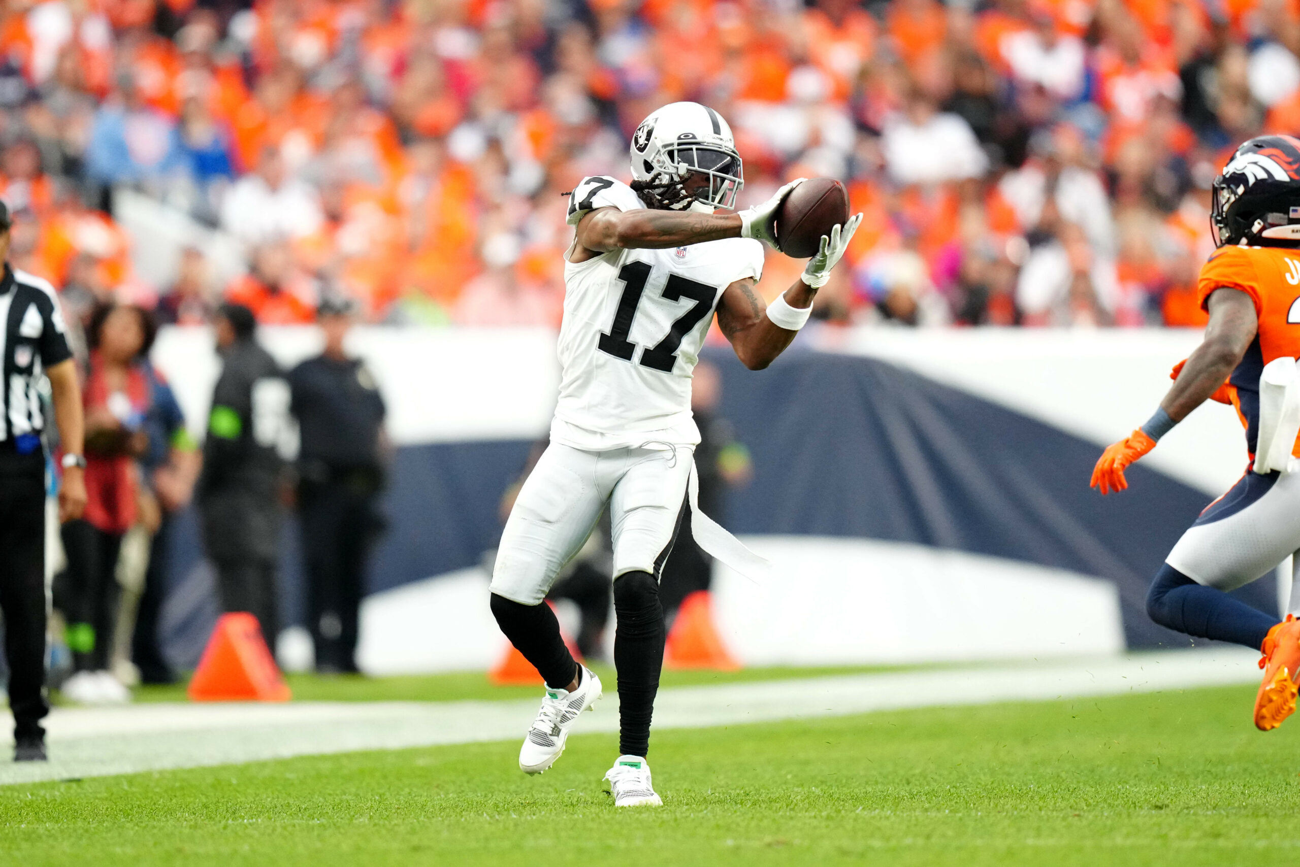 Sep 10, 2023; Denver, Colorado, USA; Las Vegas Raiders wide receiver Davante Adams (17) catches the ball in the fourth quarter against the Denver Broncos at Empower Field at Mile High. Mandatory Credit: Ron Chenoy-USA TODAY Sports