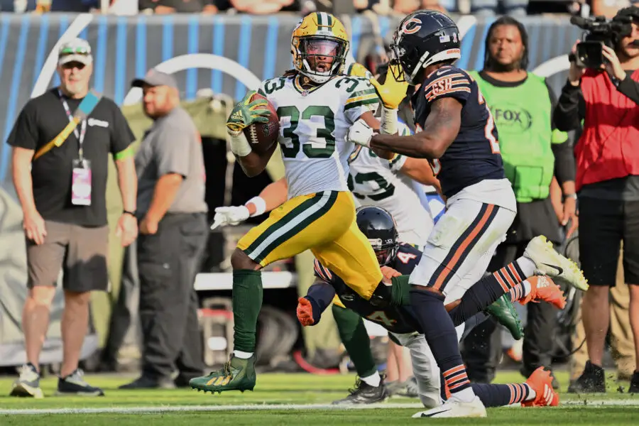 Sep 10, 2023; Chicago, Illinois, USA; Green Bay Packers running back Aaron Jones (33) fends off Chicago Bears defensive back Tyrique Stevenson (29) on a 51-yard pass play in the second half at Soldier Field. Mandatory Credit: Jamie Sabau-USA TODAY Sports