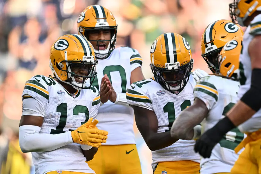 Sep 10, 2023; Chicago, Illinois, USA; Green Bay Packers wide receiver Dontayvion Wicks (13), quarterback Jordan Love (10) and wide receiver Jayden Reed (11) celebrate with running back Aaron Jones (33) after a touchdown in the second half against the Chicago Bears at Soldier Field. Mandatory Credit: Jamie Sabau-USA TODAY Sports