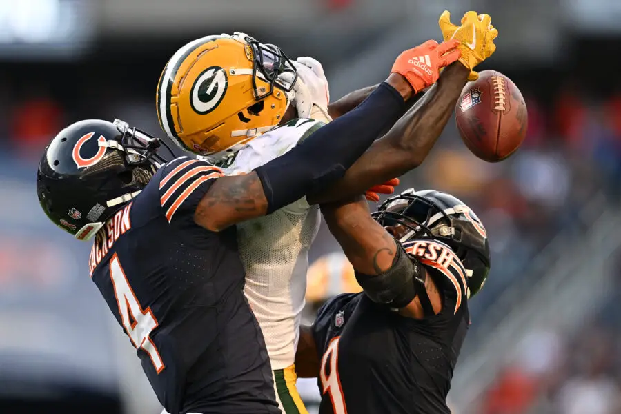 Sep 10, 2023; Chicago, Illinois, USA; Green Bay Packers wide receiver Jayden Reed (11) battles with Chicago Bears defensive back Eddie Jackson (4) and defensive back Jaquan Brisker (9) for a pass in the second half at Soldier Field. Mandatory Credit: Jamie Sabau-USA TODAY Sports