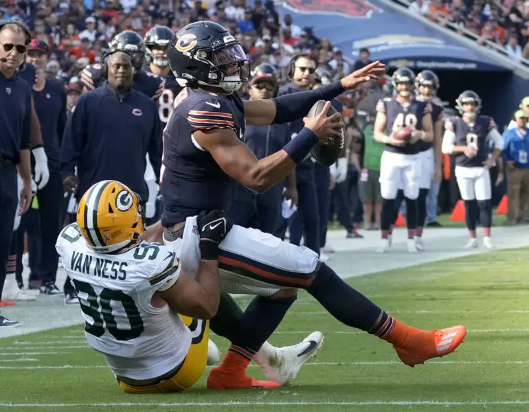 Sep 10, 2023; Chicago, Illinois, USA; Green Bay Packers linebacker Lukas Van Ness (90) makes an open field table to Chicago Bears quarterback Justin Fields (1) near the end zone during the second quarter at Soldier Field. Mandatory Credit: Mike De Sisti-USA TODAY Sports