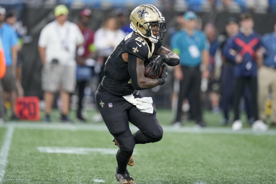Sep 18, 2023; Charlotte, North Carolina, USA; New Orleans Saints running back Jamaal Williams (21) runs against the New Orleans Saints during the first quarter at Bank of America Stadium. Mandatory Credit: Jim Dedmon-USA TODAY Sports (Green Bay Packers)